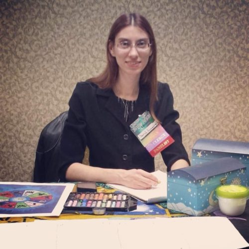 Photo of Sarah O=Malley sitting at a vendor's table