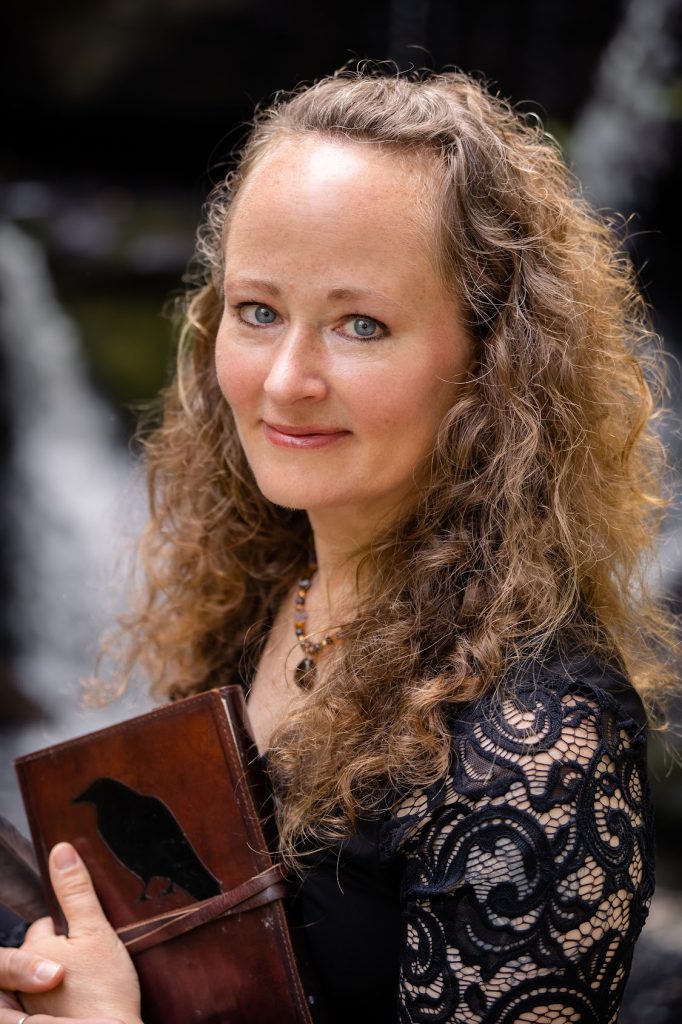 Photo of Nikki Wardwell Sleath, holding a book