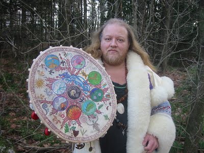 Shaman Raven Kaldera holding a painted drum